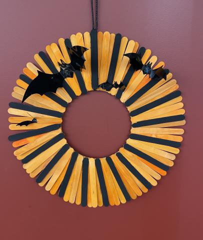 Orange and black wreath with bats