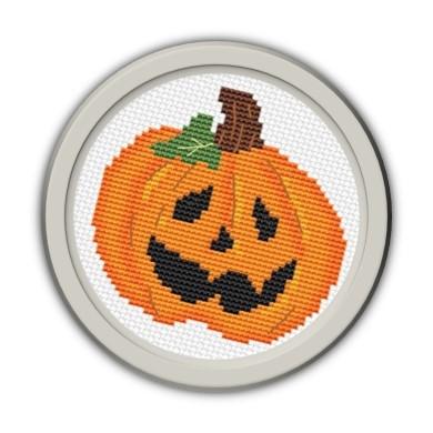 Jack-o'-lantern cross stitched and framed in gray circle. 