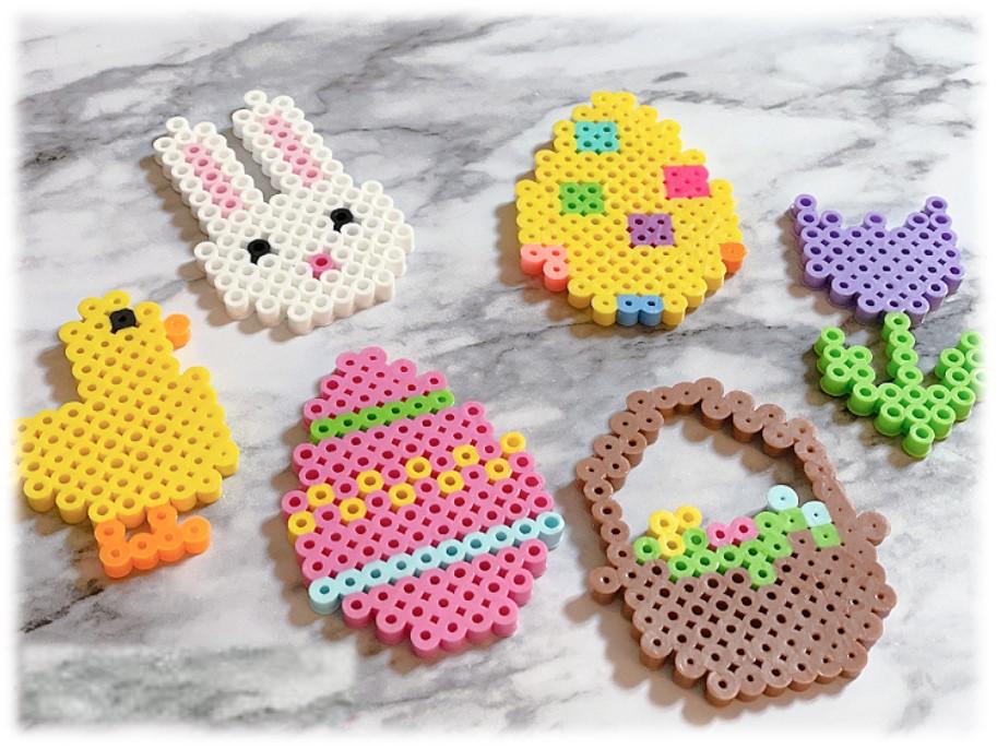Duck, rabbit head, two Easter eggs, an Easter basket, and a tulip crafted with perler beads.