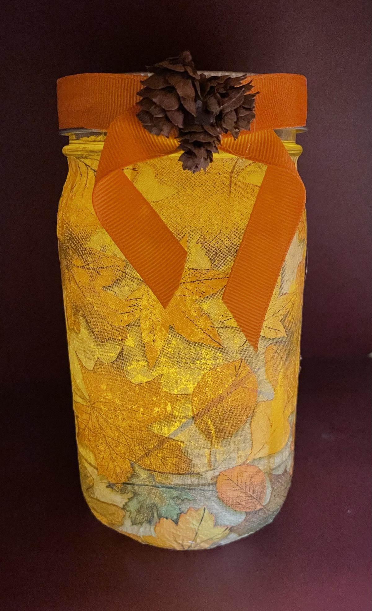 Glass jar with fall leaves. 