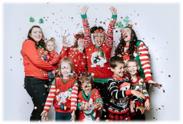 NINE FAMILY MEMBERS WEARING RED AND GREEN UGLY SWEATERS AND THROWING CONFETTI